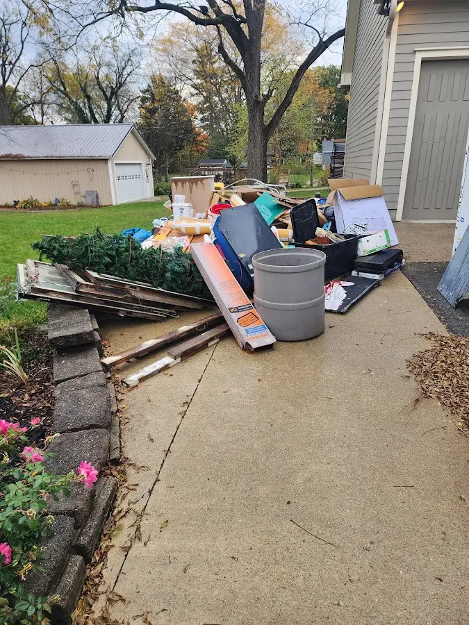 Dumpster being loaded with debris for Estate Cleanout Dumpster Rental in Ogden